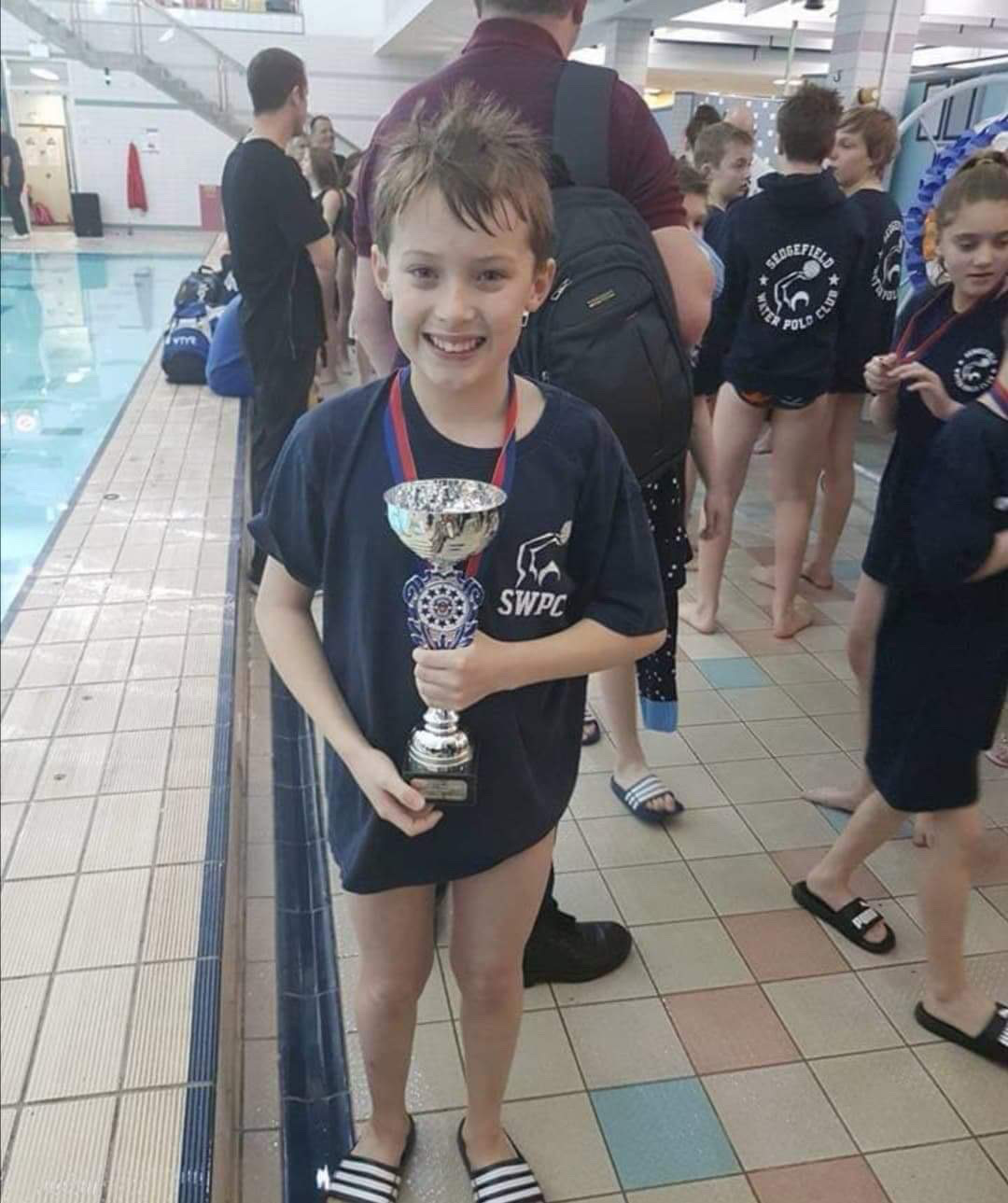 a child receiving a trophy
