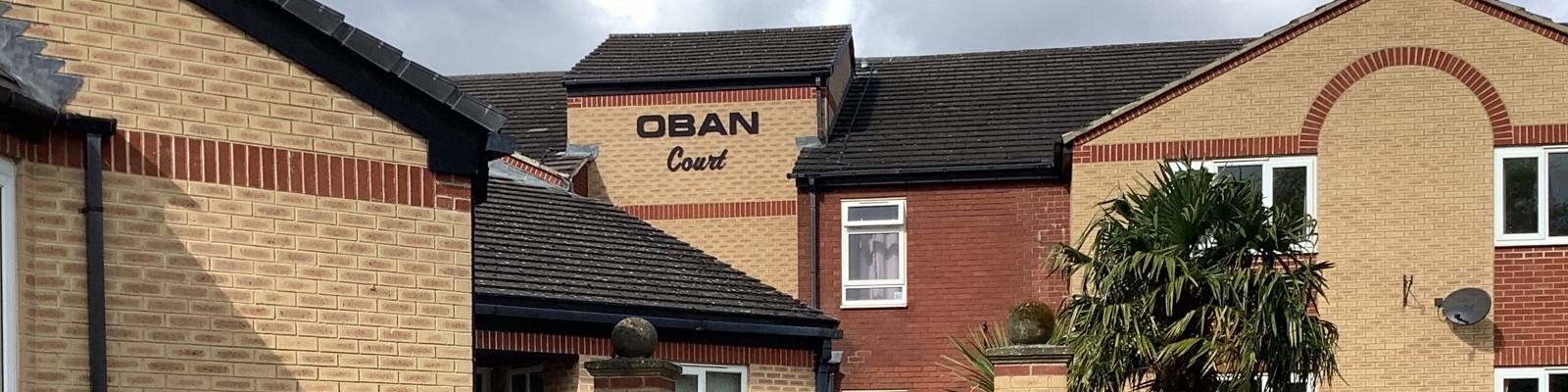 the front of Oban Court including the sign on the building