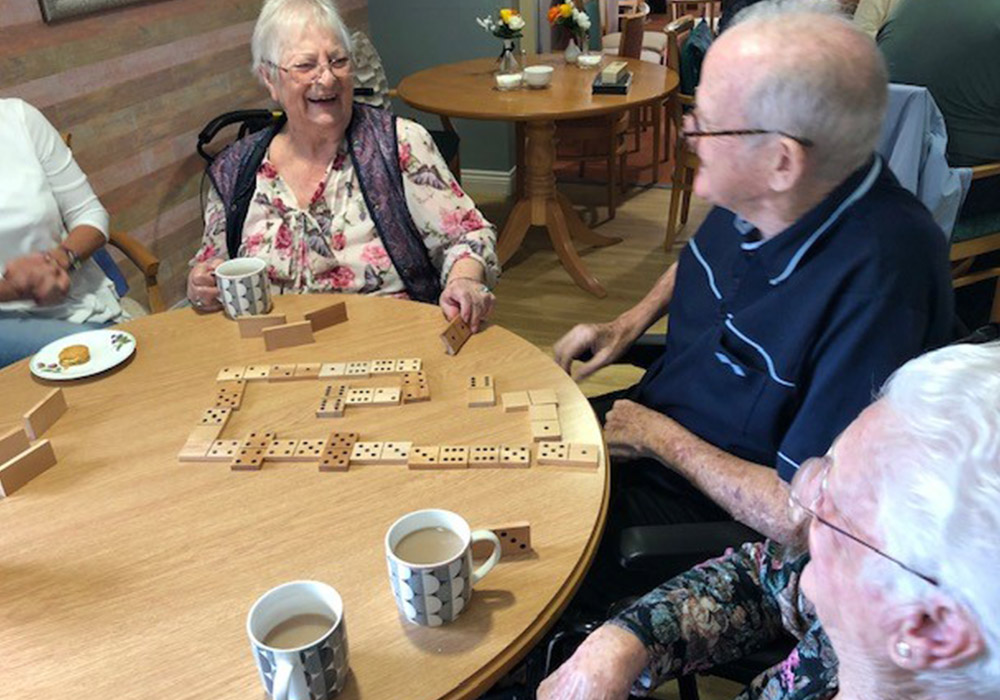 residents enjoying a game of dominoes
