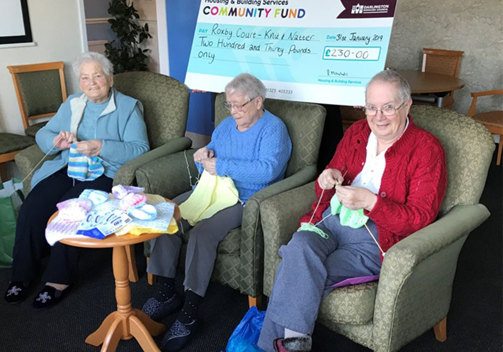 the knitting group receiving a cheque