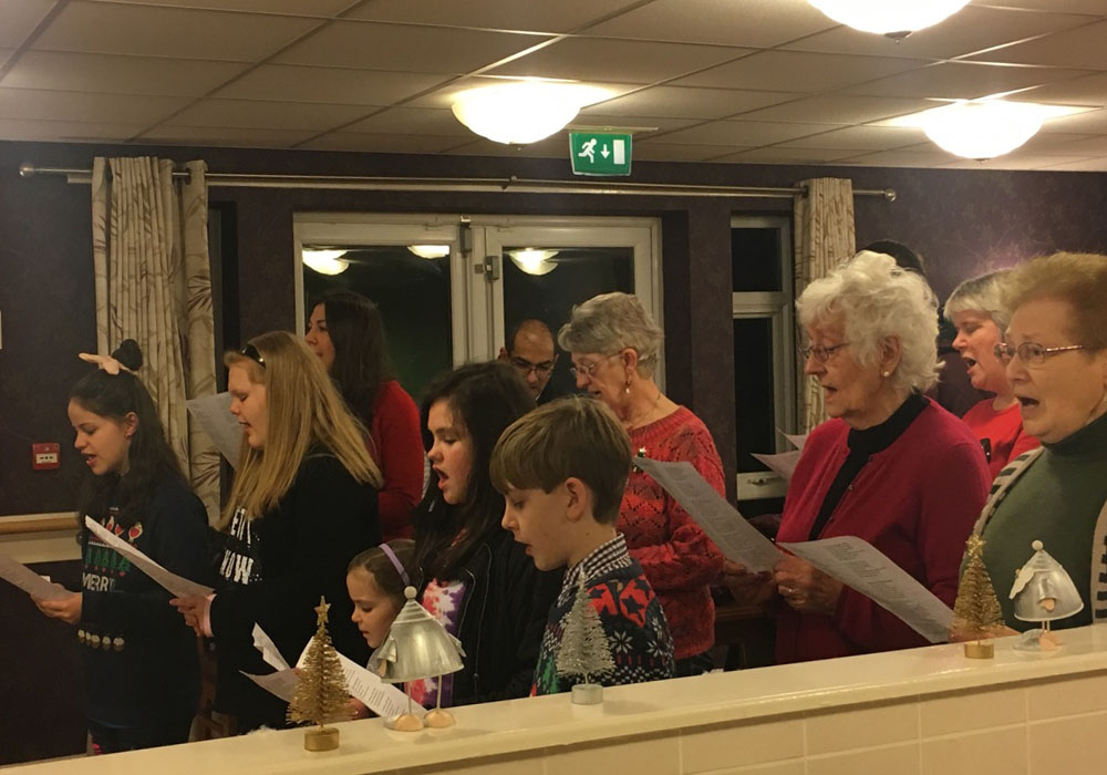 a choir singing with the residents
