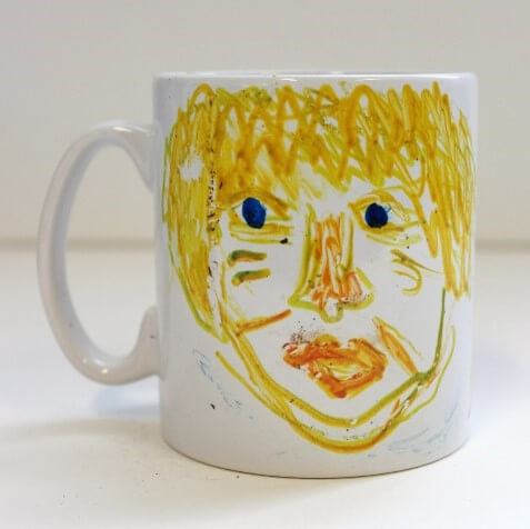 Hand painted yellow face on a mug