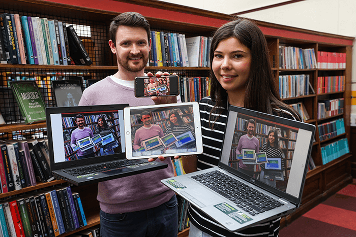 a aman and a woman displaying serveral digital devices
