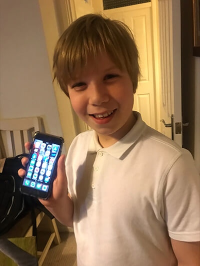 A boy holding a phone