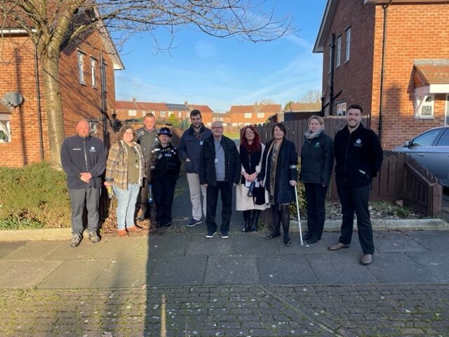Group of people posing for photo on housing estatee