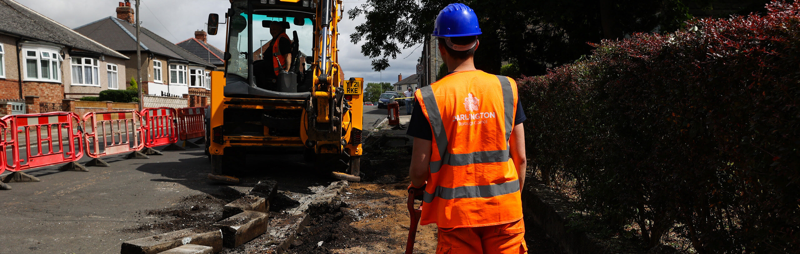 Roadworks in progress with a man in a digger