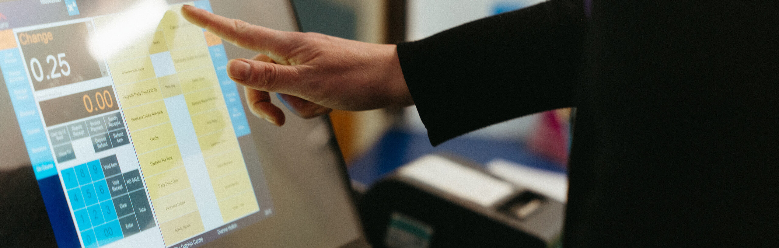 A person touching a touchscreen terminal