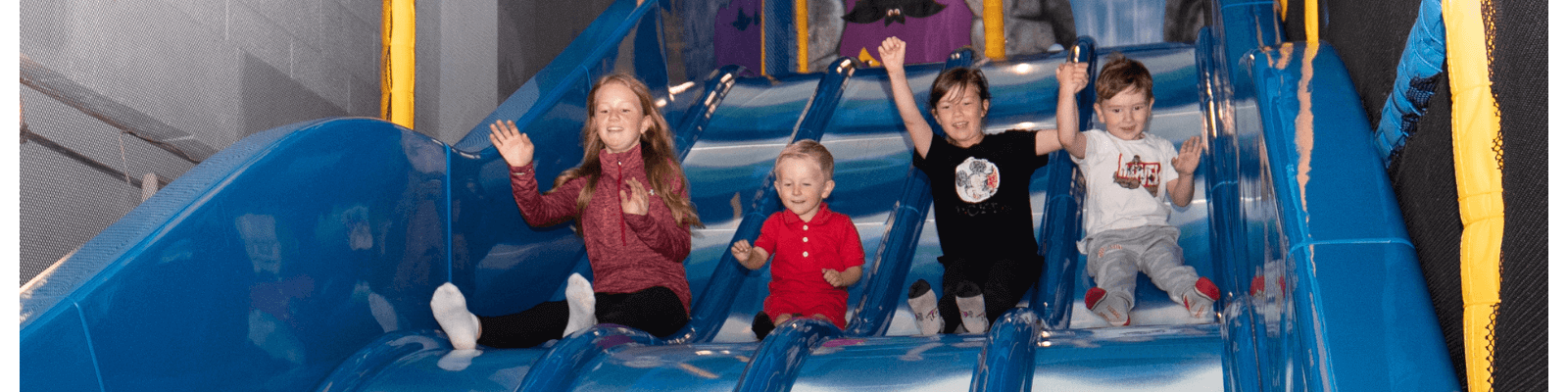 Children going down a multi lane slide