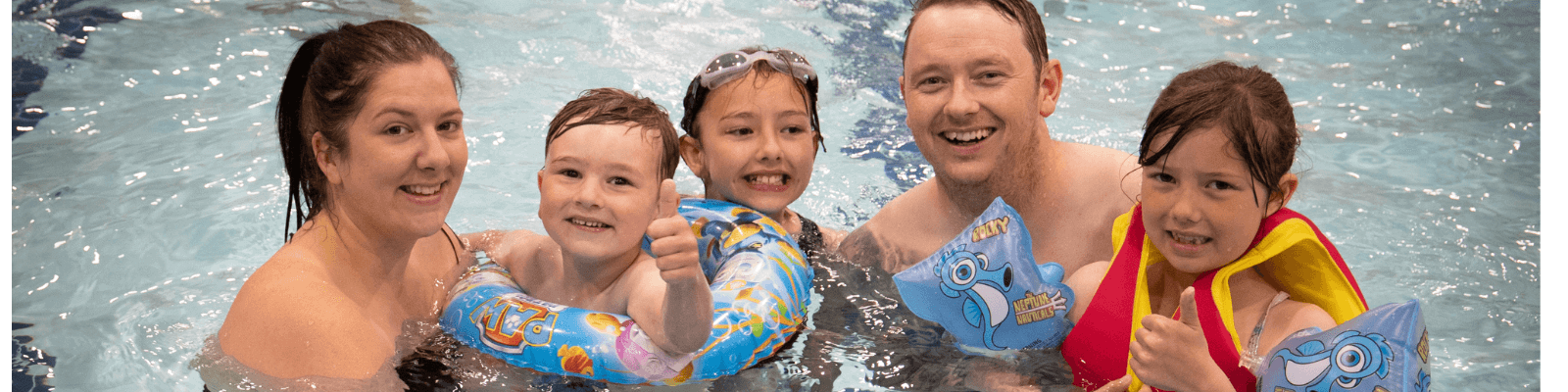 A family with 3 children in the pool at the Dolphin Centre