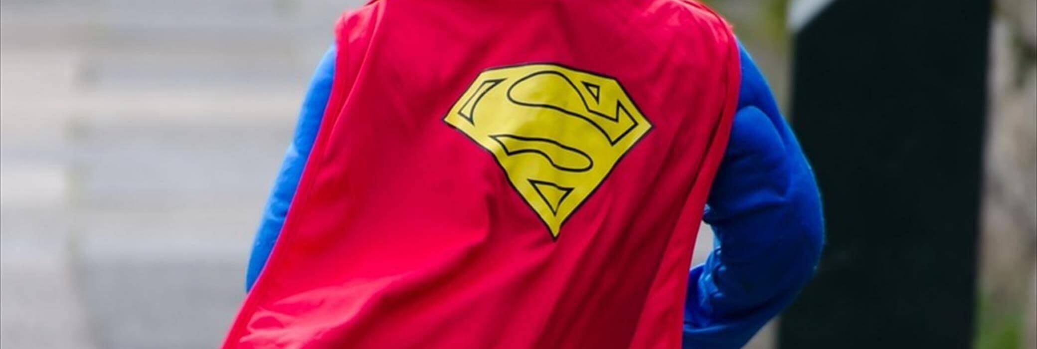 A young child dressed up as superman