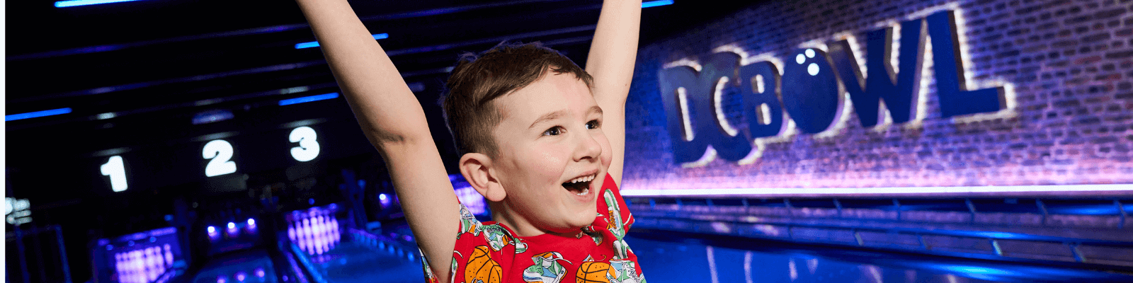 A young boy cheering at DC Bowl