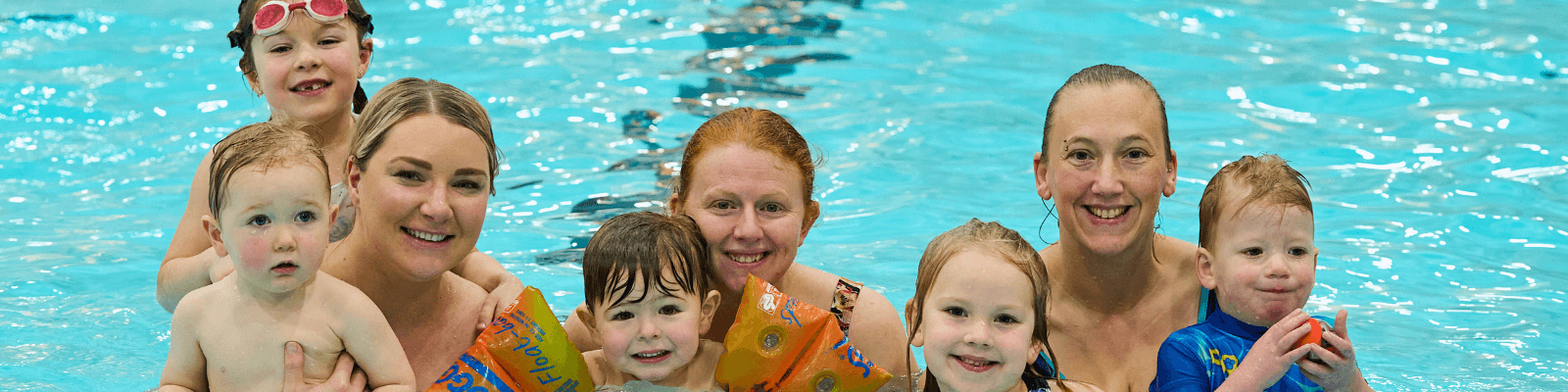 Parents and children in the dolphin centre pool