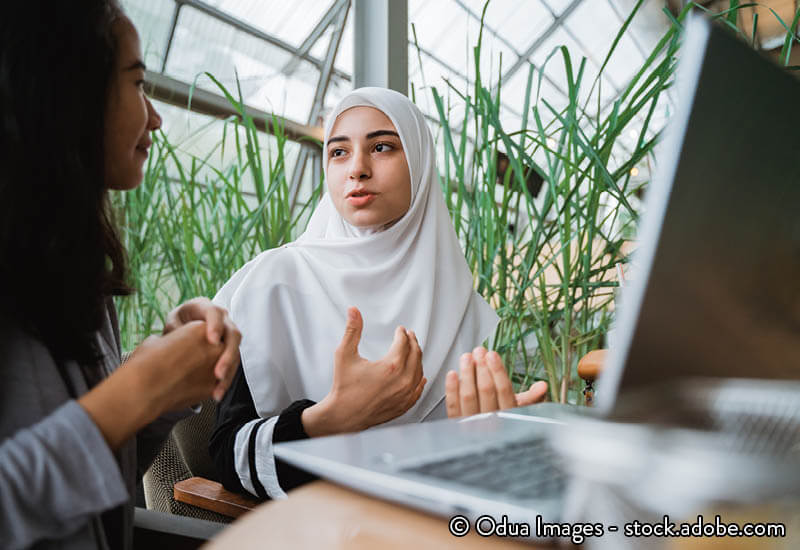 Two young women talking