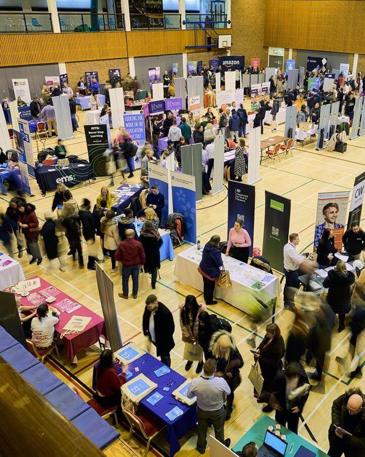 People walking around stalls at the jobs fair