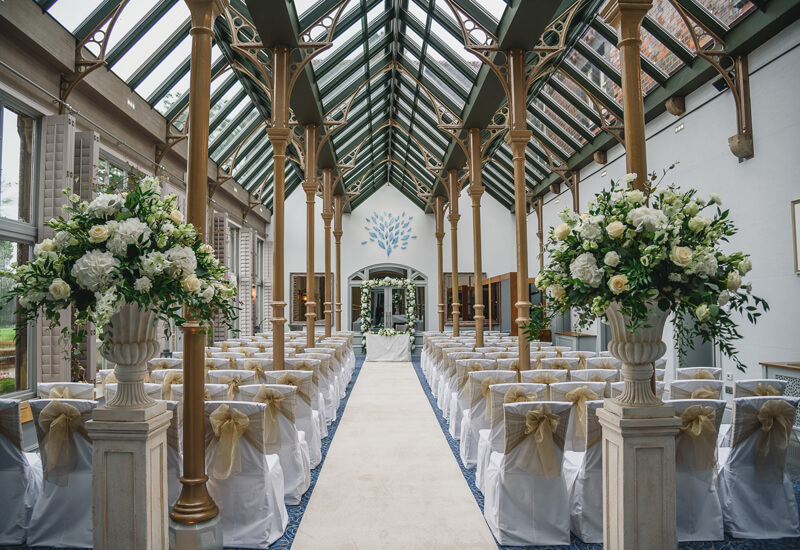 Large conservatory set out for wedding ceremony