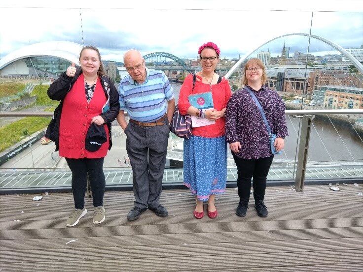 4 people stood on a bridge overlooking Sunderland