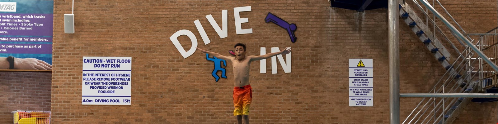 a child bouncing on the diving board